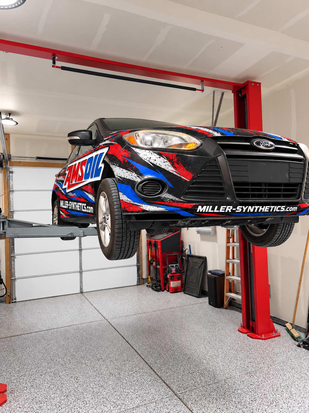 AMSOIL-wrapped vehicle receiving an oil change inside a service bay